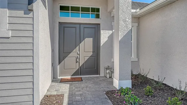 a living room with furniture a large window and a flat screen tv