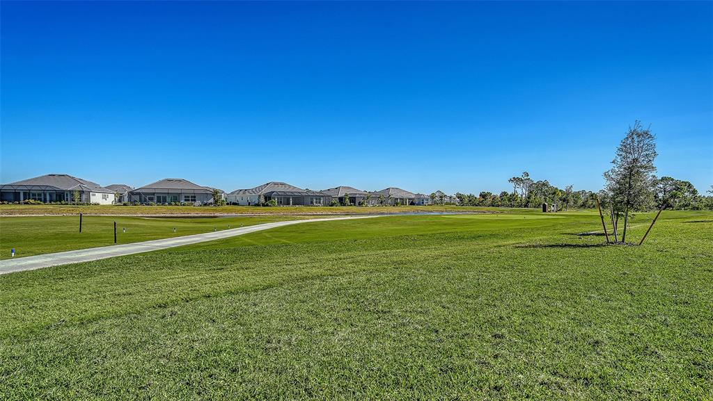 17160 Albatross Road Venice, FL 34293 - Photo 42 of 91 a view of a golf course with a lake