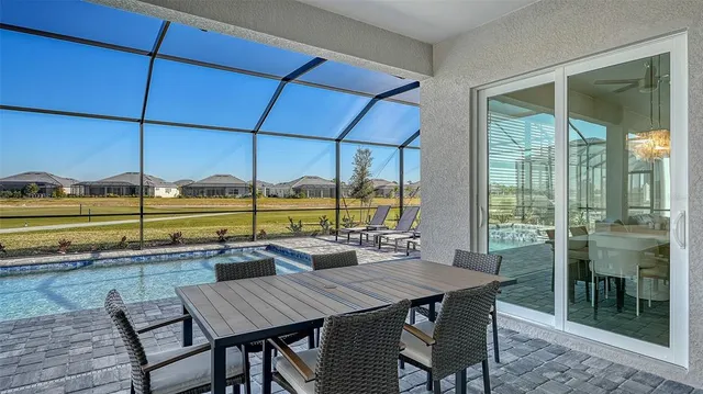 a large kitchen with kitchen island a large counter space a sink stainless steel appliances and cabinets