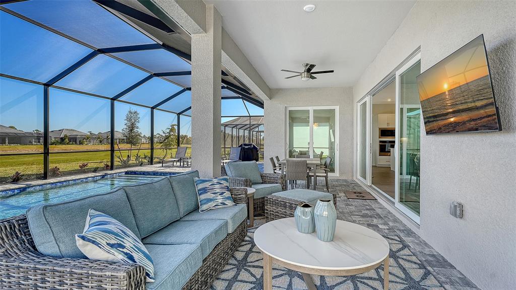 17160 Albatross Road Venice, FL 34293 - Photo 10 of 91 a living room with furniture and a floor to ceiling window