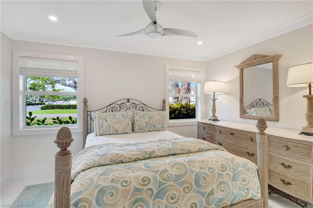 603 12th Avenue South Naples, FL 34102 - Photo 11 of 47 a bedroom with a large bed and a dresser
