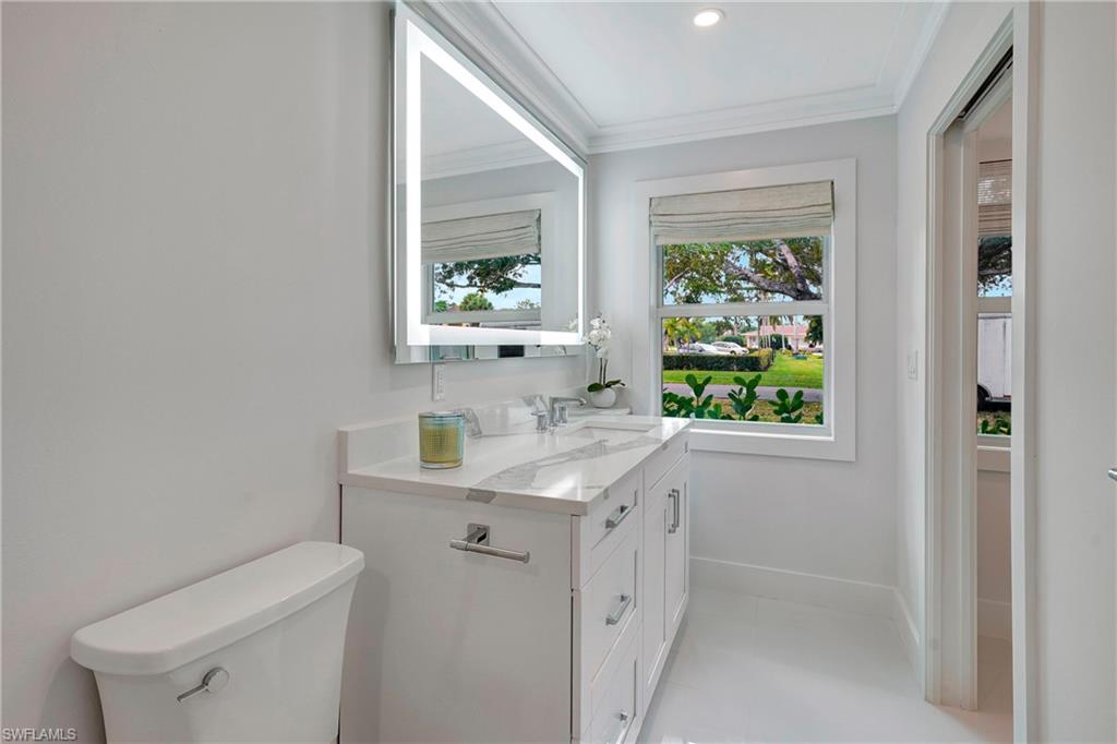603 12th Avenue South Naples, FL 34102 - Photo 16 of 47 a view of bathroom with a toilet sink and mirror