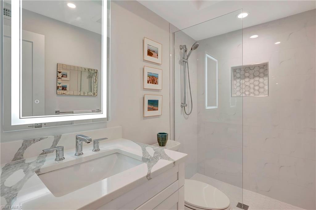 603 12th Avenue South Naples, FL 34102 - Photo 21 of 47 a bathroom with a sink toilet and a mirror