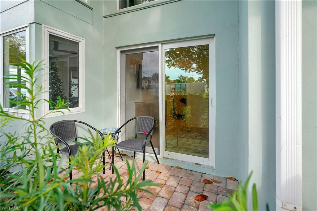 603 12th Avenue South Naples, FL 34102 - Photo 22 of 47 a balcony with table and chairs and potted plants