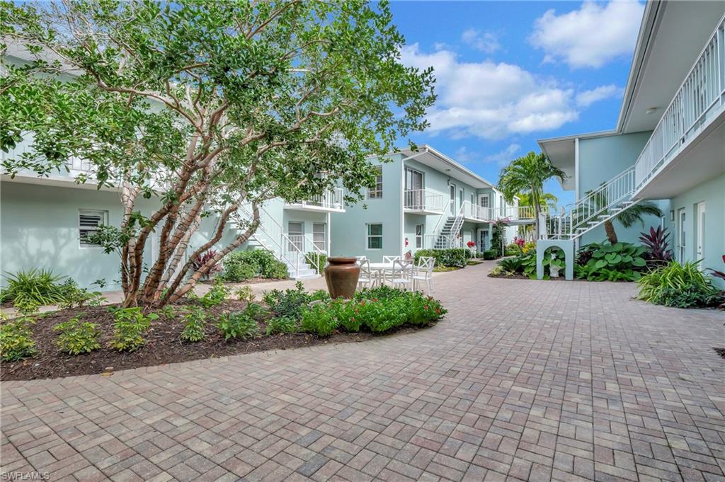 603 12th Avenue South Naples, FL 34102 - Photo 26 of 47 a view of road and yard with large trees