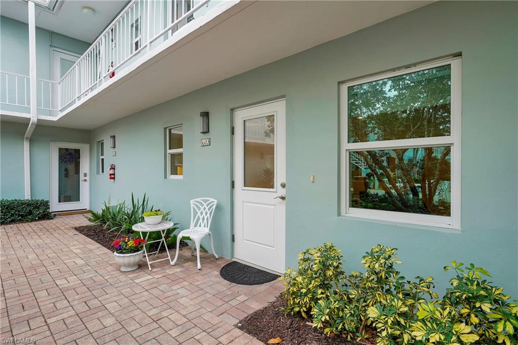603 12th Avenue South Naples, FL 34102 - Photo 27 of 47 a view of a entryway with flower pots