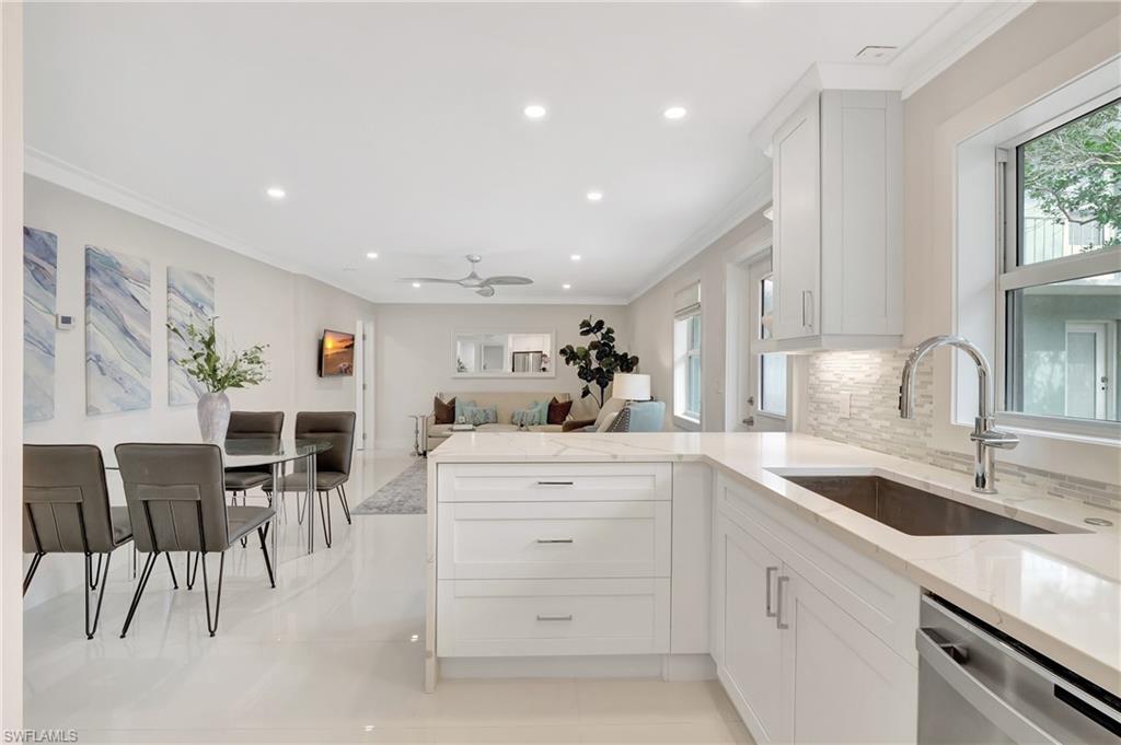 603 12th Avenue South Naples, FL 34102 - Photo 3 of 47 a kitchen with a sink stainless steel appliances and white cabinets