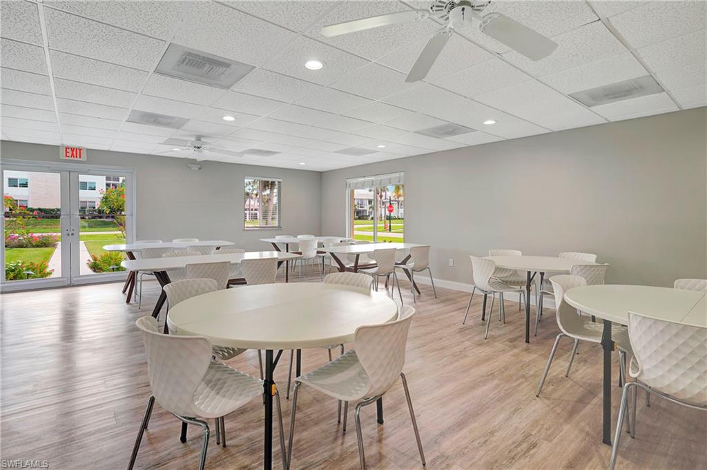 603 12th Avenue South Naples, FL 34102 - Photo 45 of 47 a view of a dining room with furniture window and wooden floor
