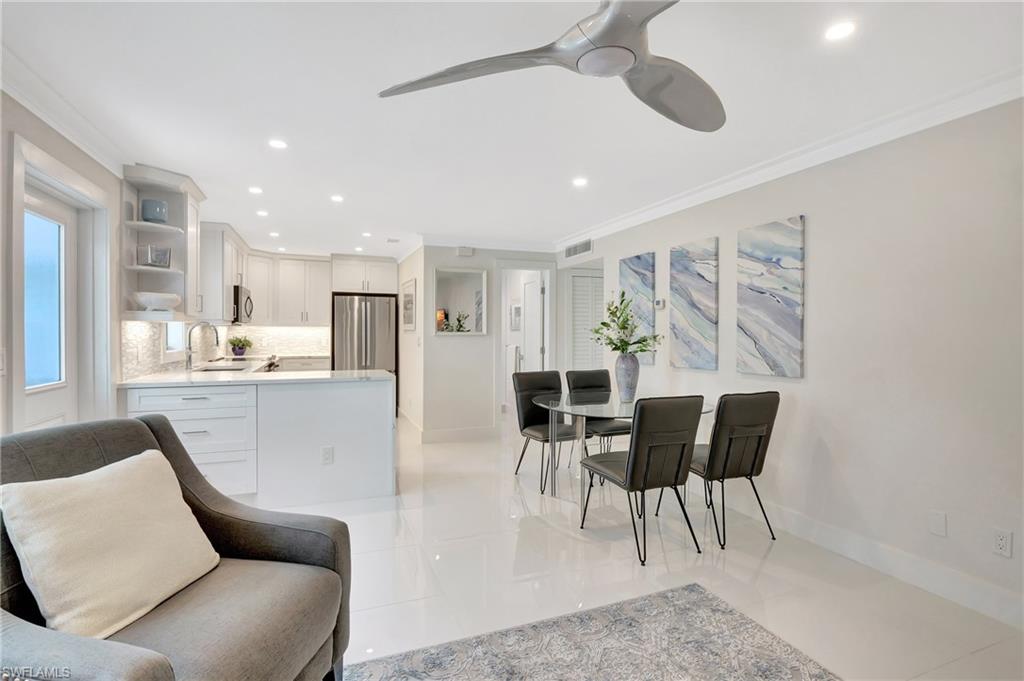 603 12th Avenue South Naples, FL 34102 - Photo 10 of 47 a living room with furniture and kitchen view