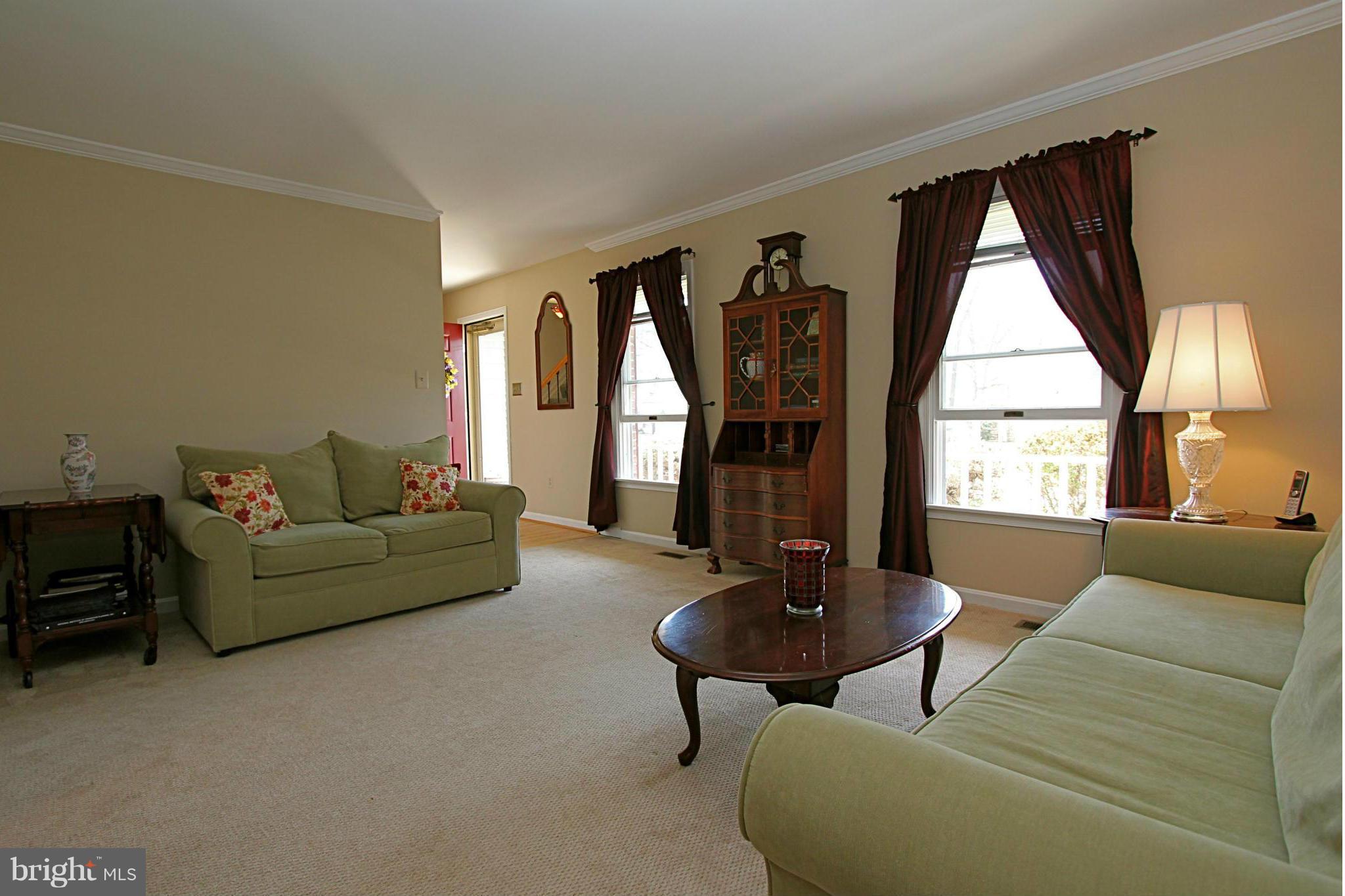 9338 Ramblebrook Road Baltimore, MD 21236 - Photo 2 of 25 a living room with furniture and a large window