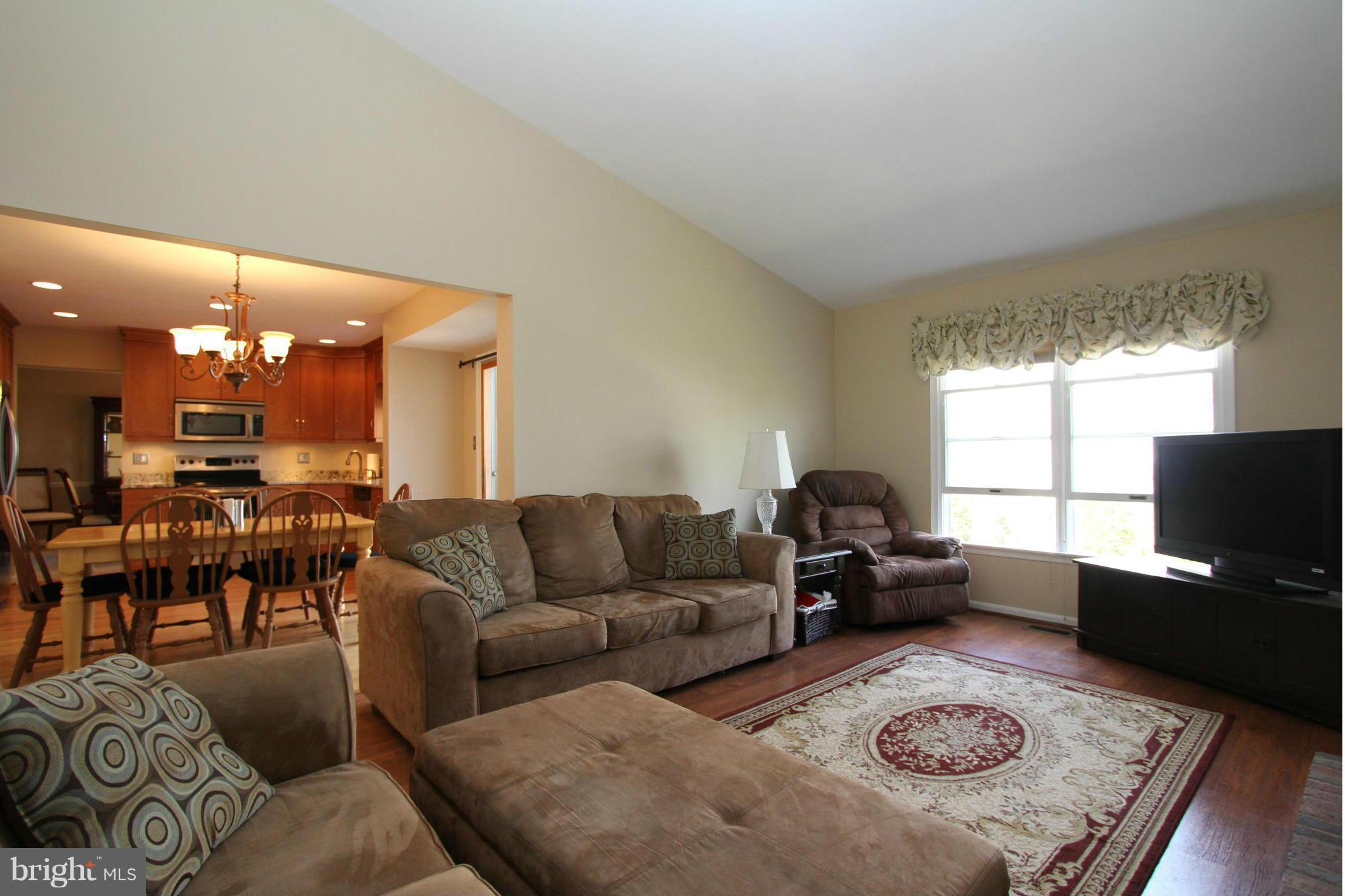 9338 Ramblebrook Road Baltimore, MD 21236 - Photo 11 of 25 a living room with furniture and a flat screen tv