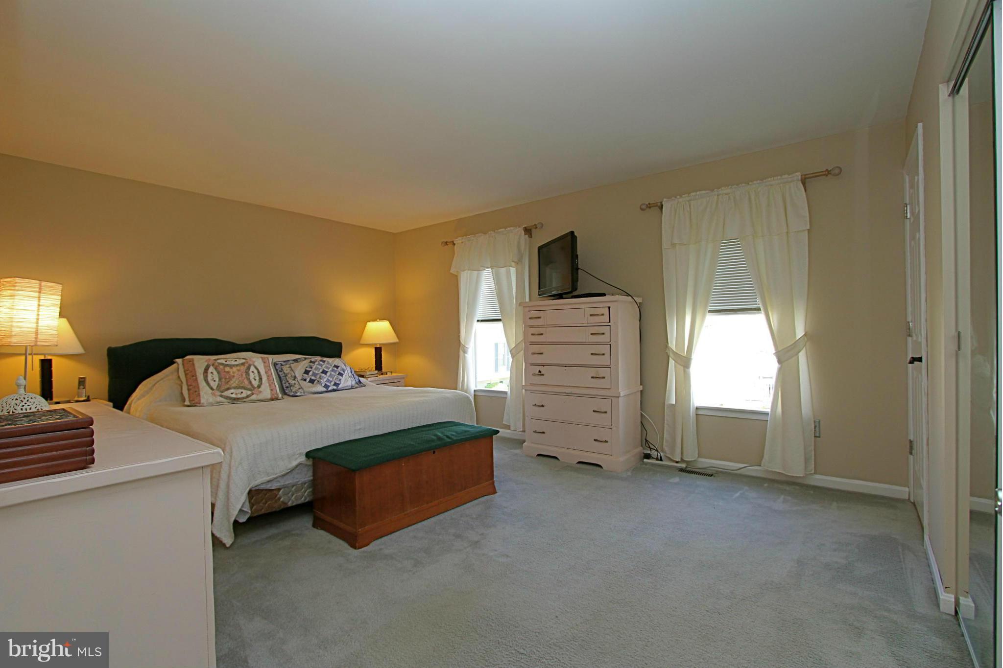 9338 Ramblebrook Road Baltimore, MD 21236 - Photo 12 of 25 a spacious bedroom with a bed and a cabinets