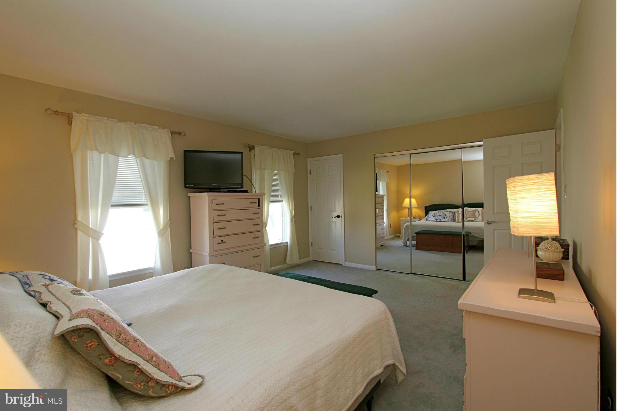 9338 Ramblebrook Road Baltimore, MD 21236 - Photo 13 of 25 a bedroom with a bed and a tv