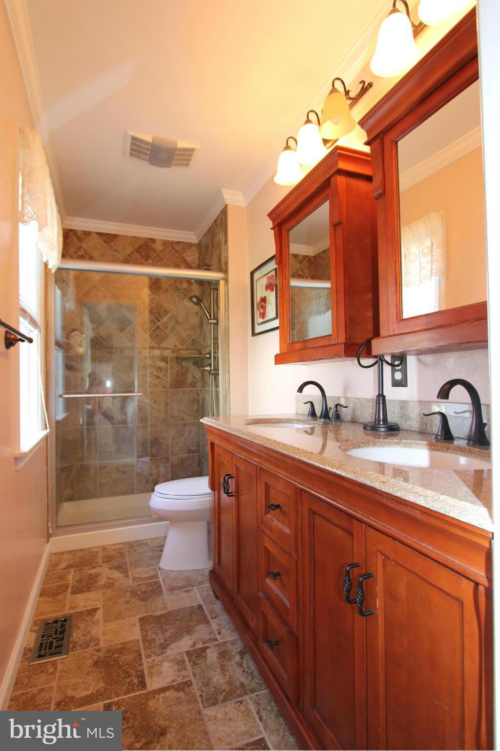 9338 Ramblebrook Road Baltimore, MD 21236 - Photo 14 of 25 a bathroom with a sink a toilet and shower