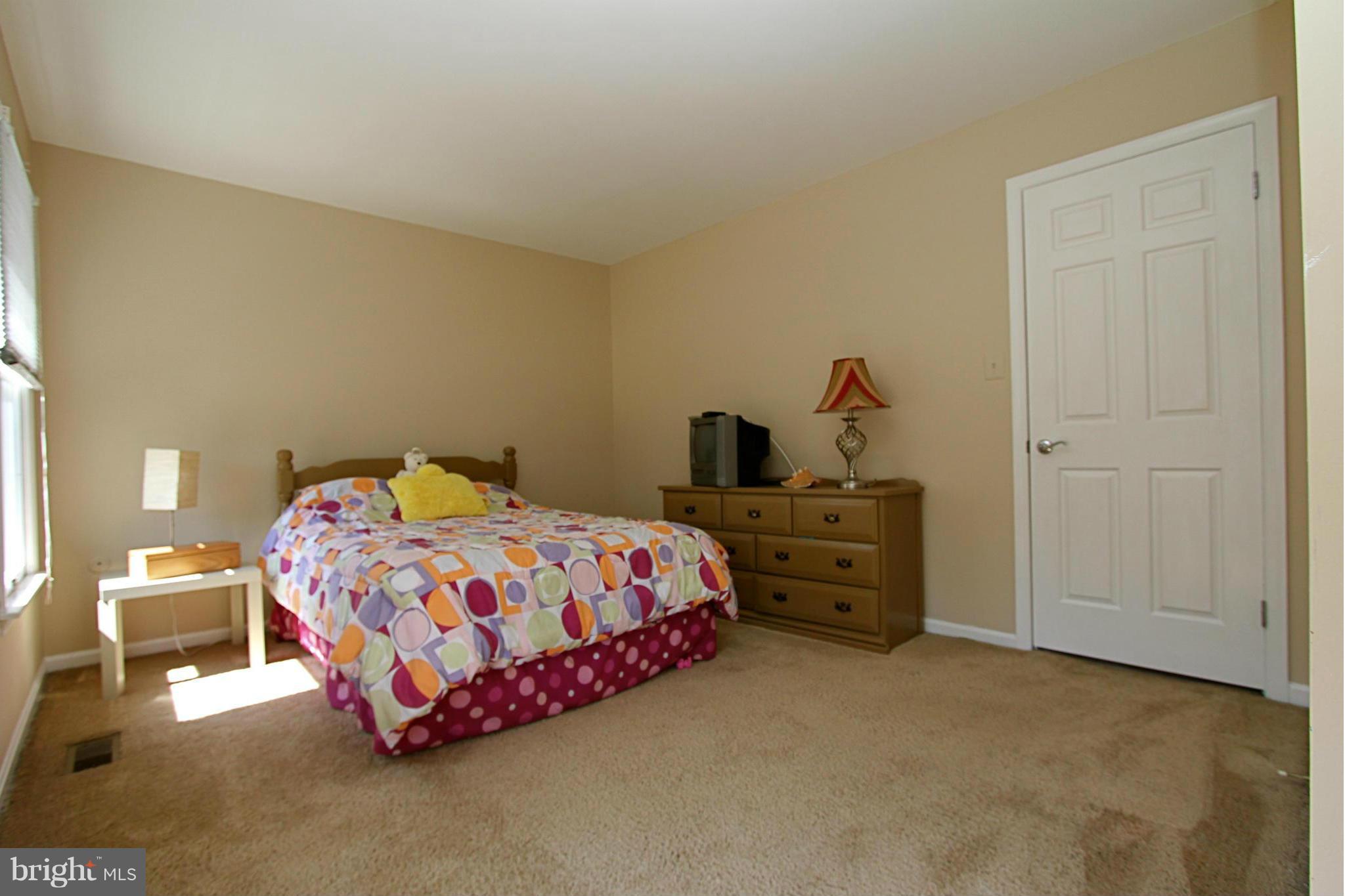 9338 Ramblebrook Road Baltimore, MD 21236 - Photo 16 of 25 a bedroom with a bed and dresser