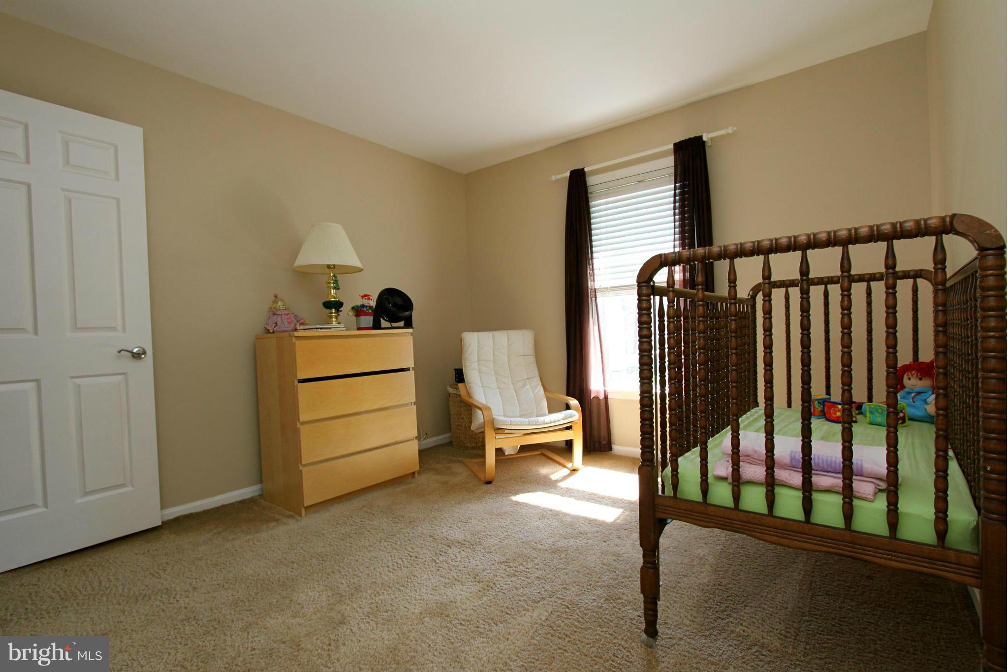 9338 Ramblebrook Road Baltimore, MD 21236 - Photo 18 of 25 a hallway with a baby crib