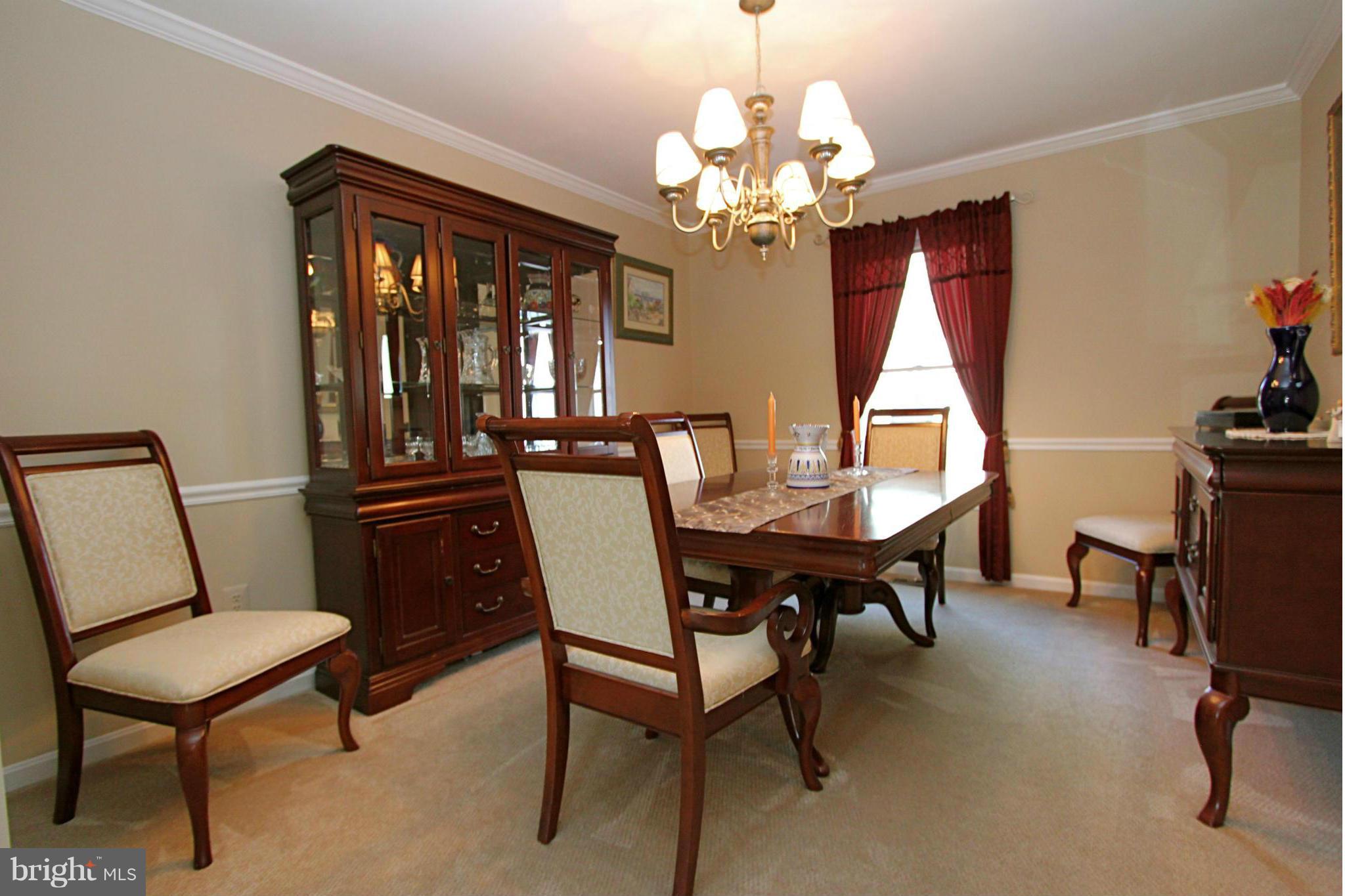 9338 Ramblebrook Road Baltimore, MD 21236 - Photo 4 of 25 a view of a dining room with furniture and a chandelier