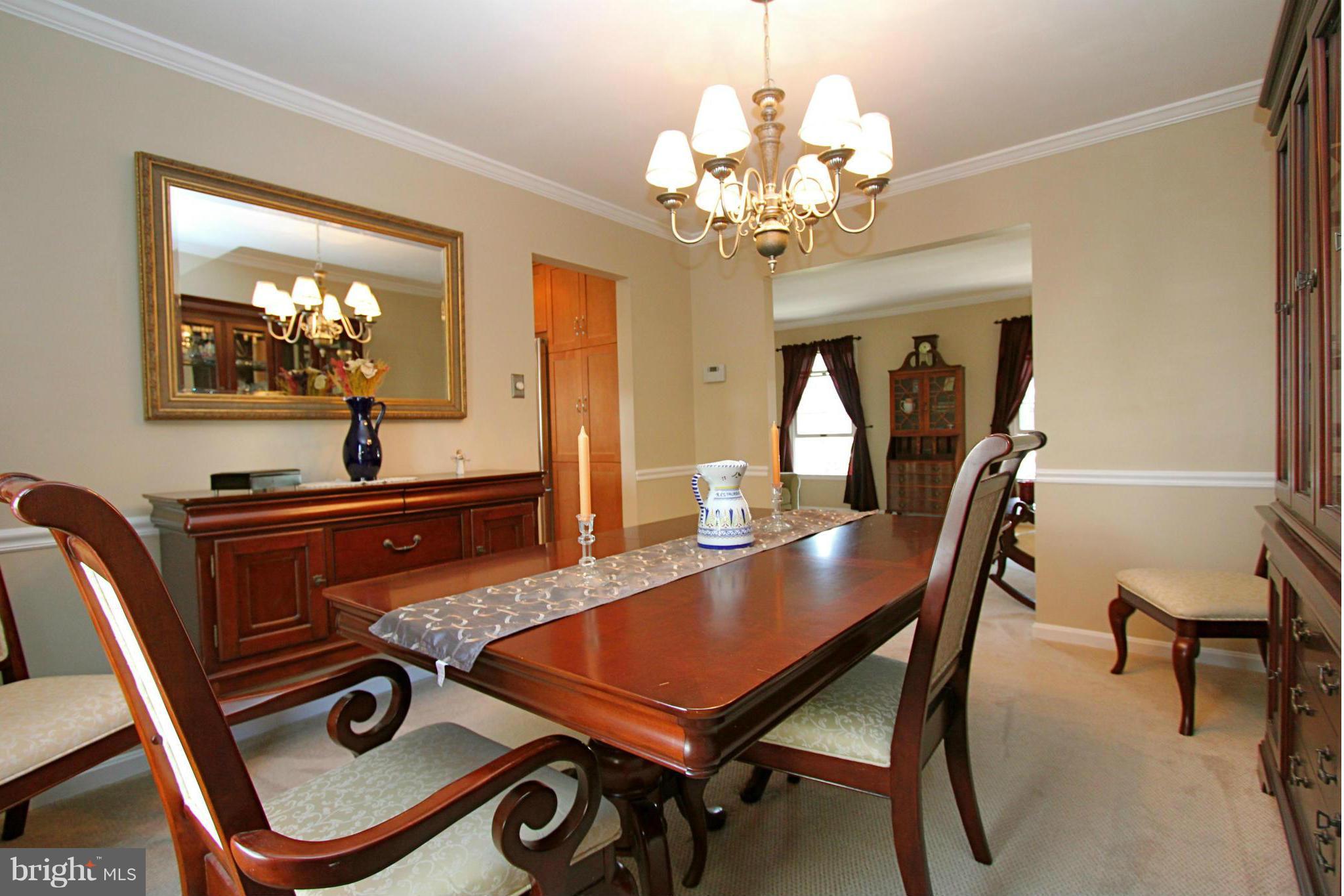 9338 Ramblebrook Road Baltimore, MD 21236 - Photo 5 of 25 a view of a dining room with furniture and a chandelier