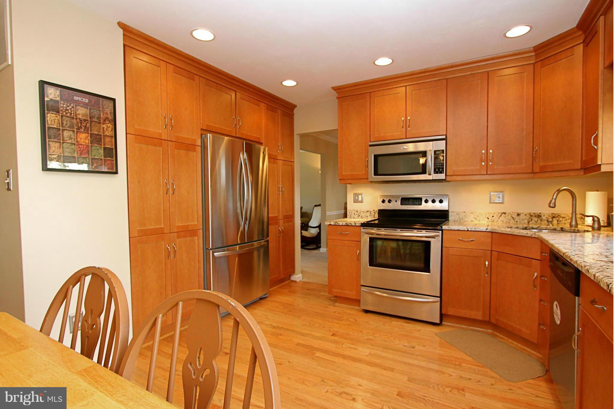 9338 Ramblebrook Road Baltimore, MD 21236 - Photo 6 of 25 a kitchen with stainless steel appliances granite countertop a stove a sink and a refrigerator