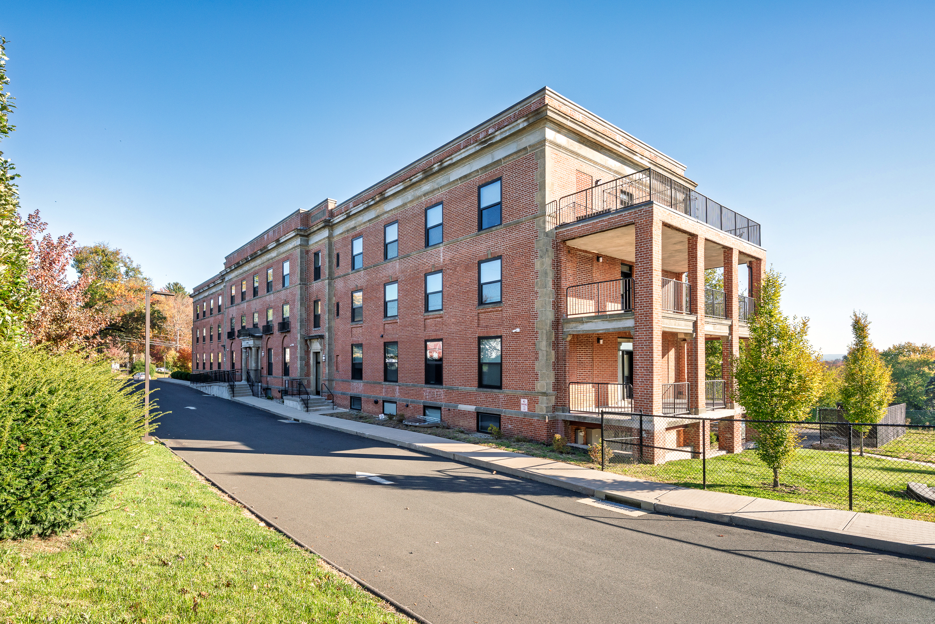 170 Ridge Road, Unit 201 Wethersfield, CT 06109 - Photo 1 of 25 a view of a tall building next to a road
