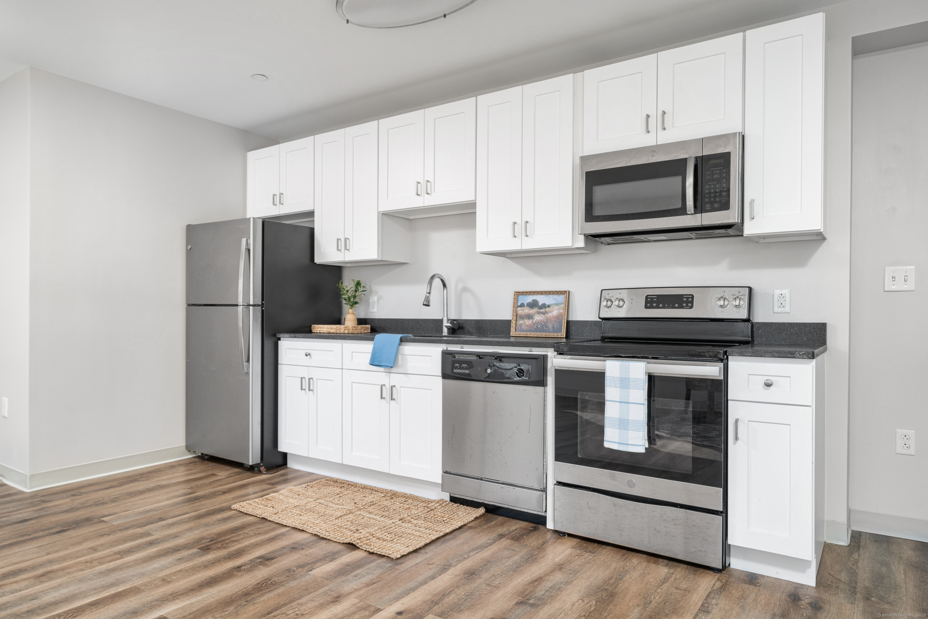 170 Ridge Road, Unit 201 Wethersfield, CT 06109 - Photo 22 of 25 a kitchen with a refrigerator stove and microwave