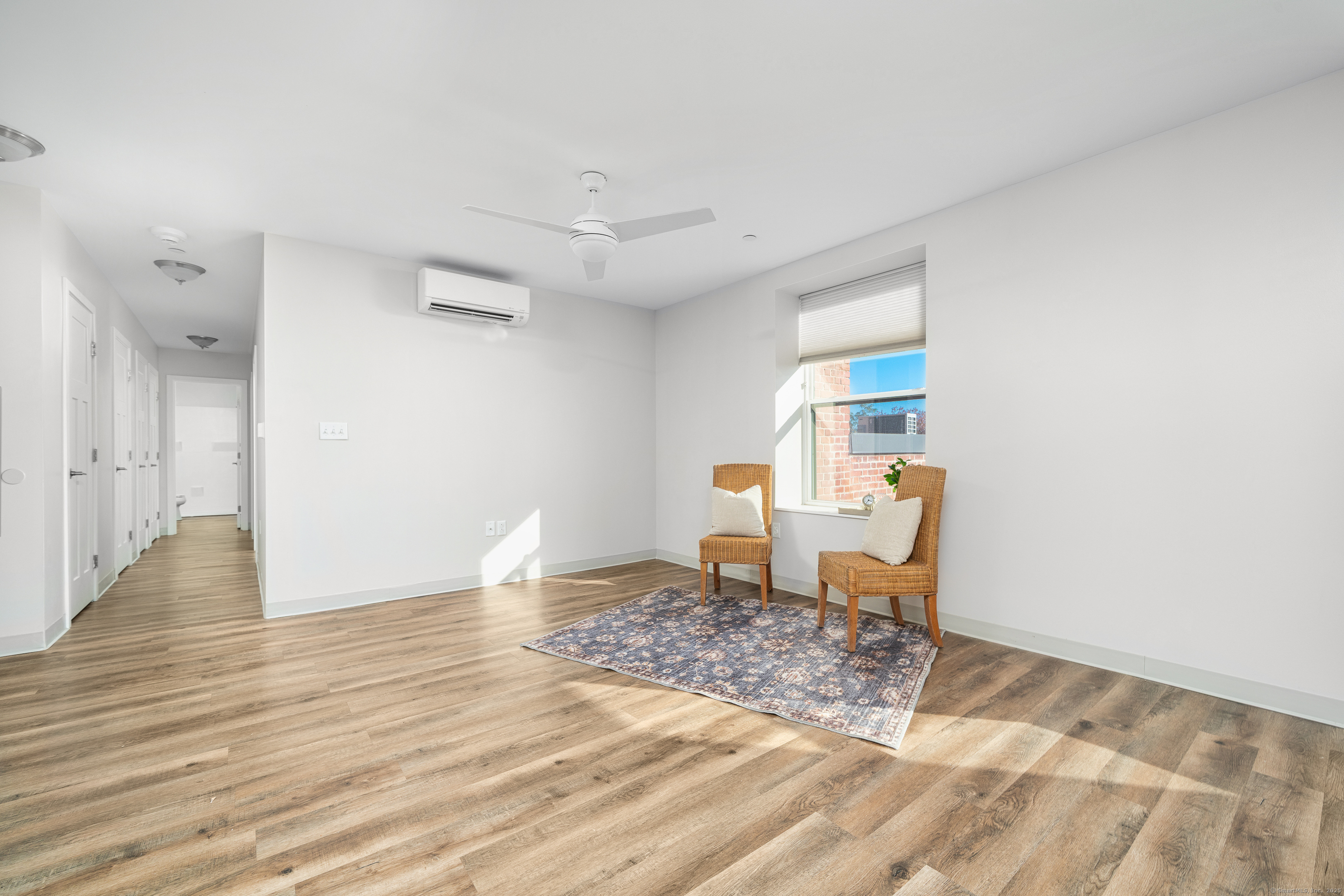170 Ridge Road, Unit 201 Wethersfield, CT 06109 - Photo 24 of 25 a view of a livingroom with wooden floor and chair