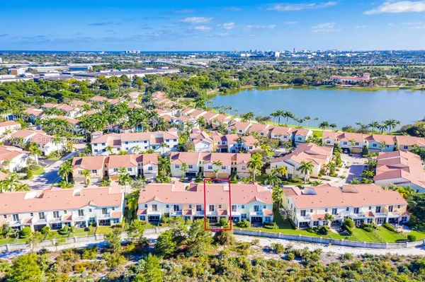 a view of a city with an ocean and houses