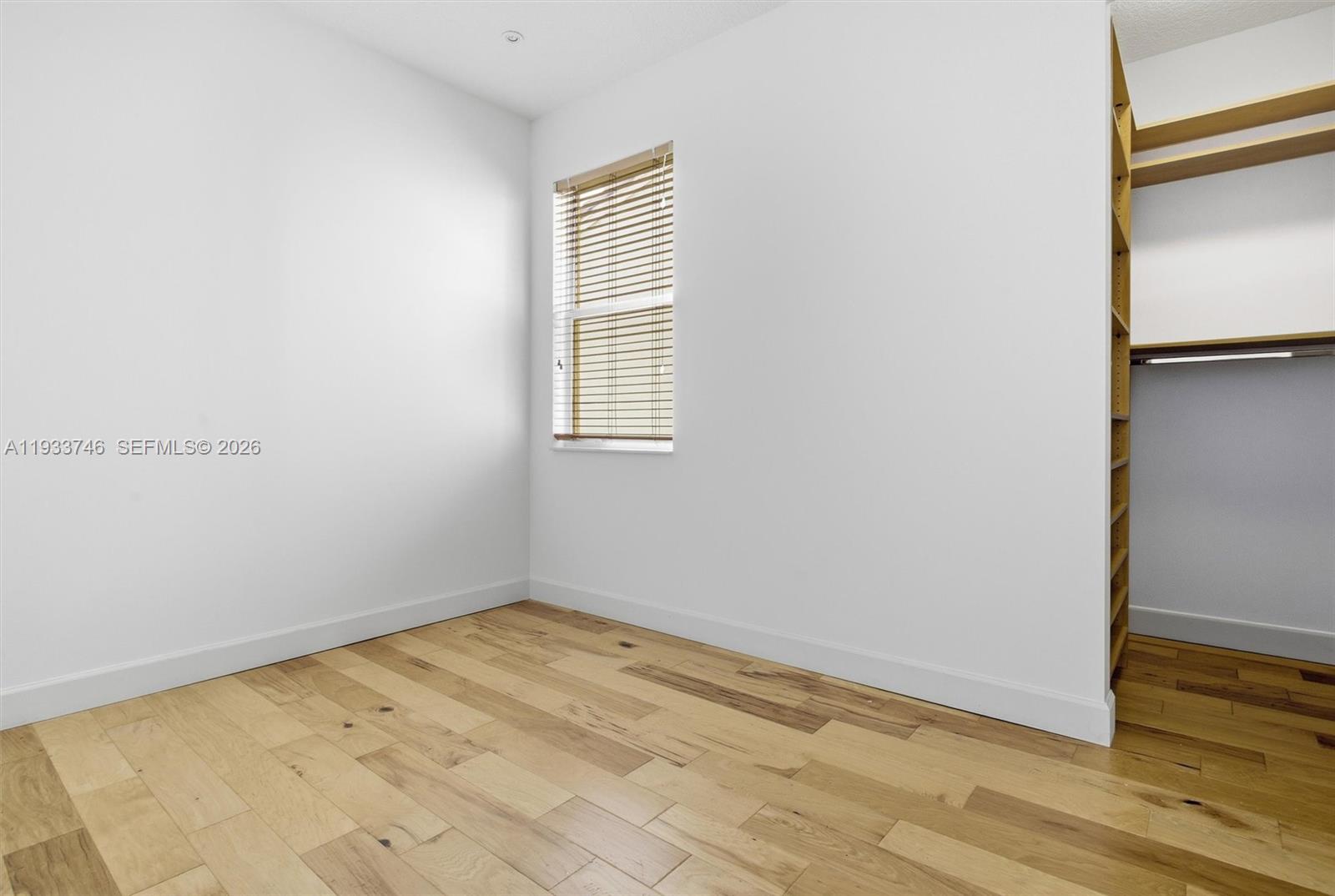 4857 Northwest 16th Terrace Boca Raton, FL 33431 - Photo 26 of 45 an empty room with wooden floor and windows