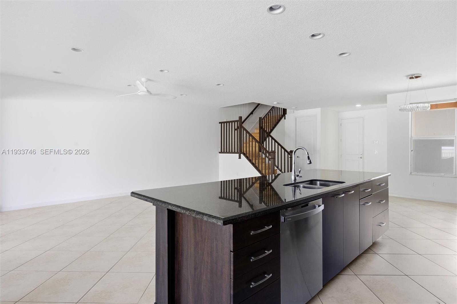 4857 Northwest 16th Terrace Boca Raton, FL 33431 - Photo 40 of 45 a kitchen with granite countertop a stove and a sink
