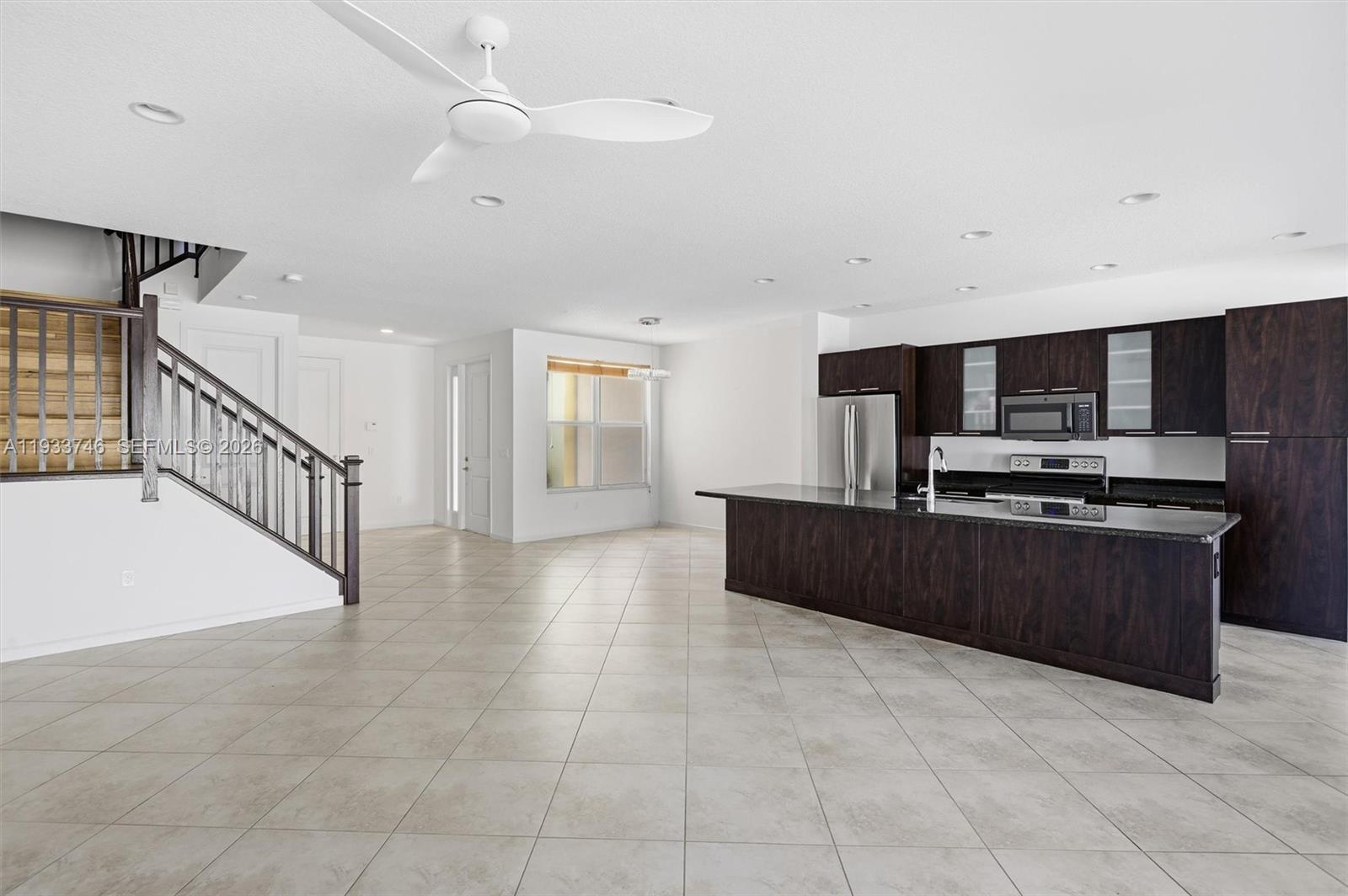 4857 Northwest 16th Terrace Boca Raton, FL 33431 - Photo 41 of 45 a kitchen with stainless steel appliances kitchen island granite countertop a refrigerator and a stove top oven