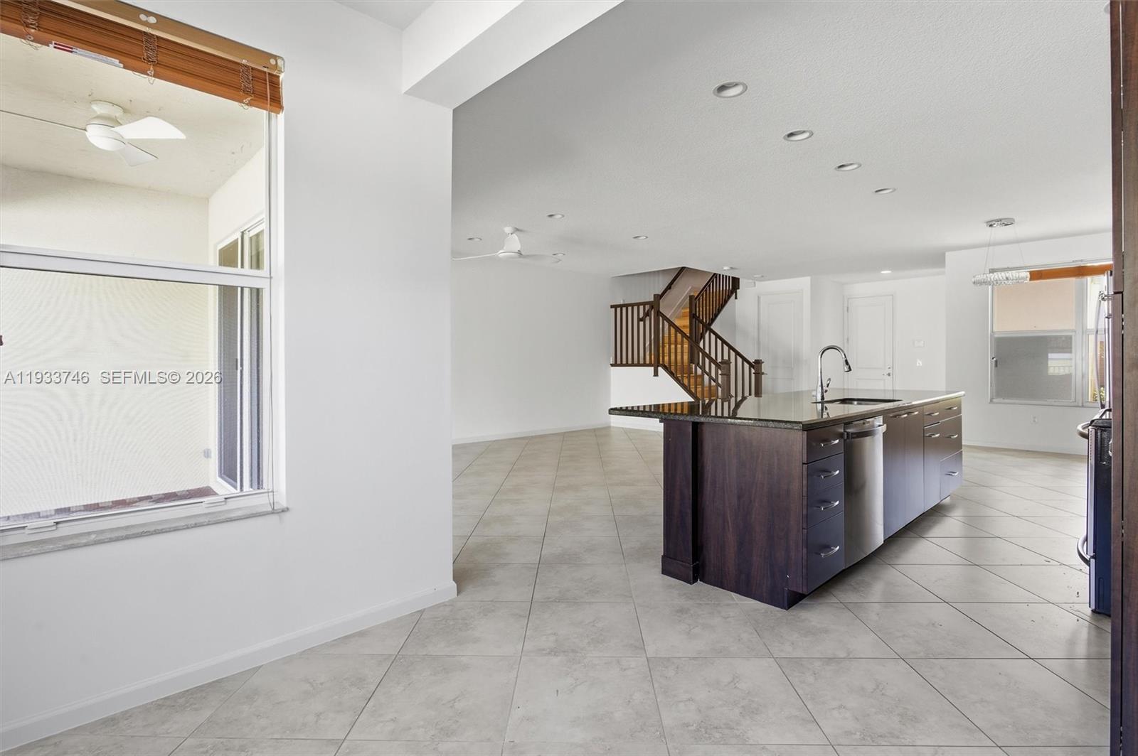 4857 Northwest 16th Terrace Boca Raton, FL 33431 - Photo 5 of 45 a kitchen with stainless steel appliances a sink and cabinets