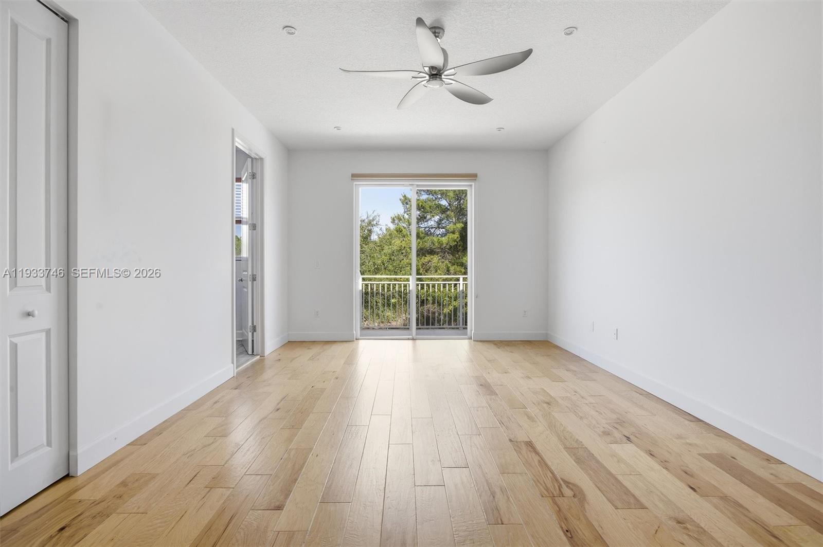 4857 Northwest 16th Terrace Boca Raton, FL 33431 - Photo 8 of 45 wooden floor in an empty room with a window
