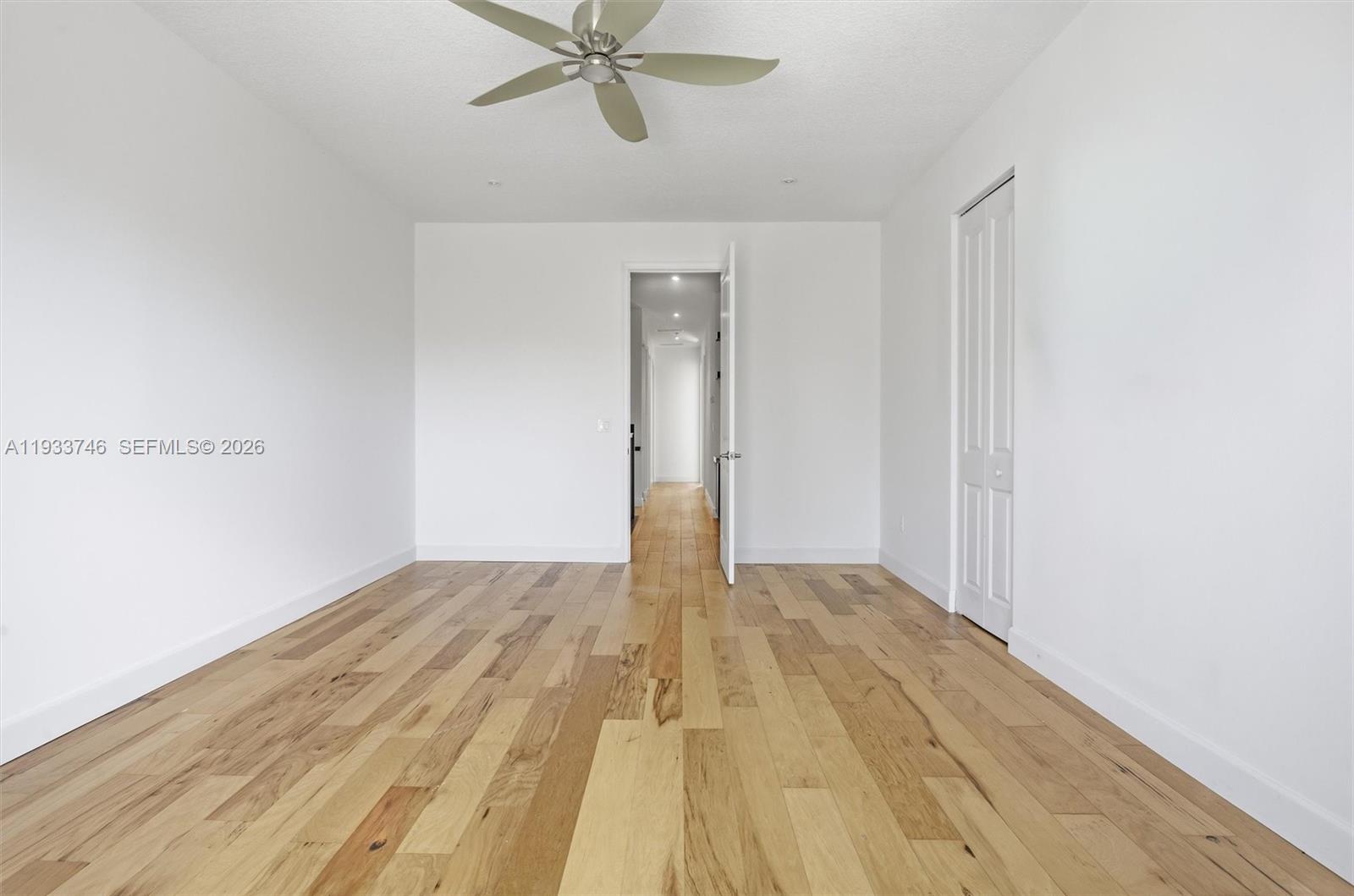 4857 Northwest 16th Terrace Boca Raton, FL 33431 - Photo 9 of 45 a view of a room with wooden floor and white walls