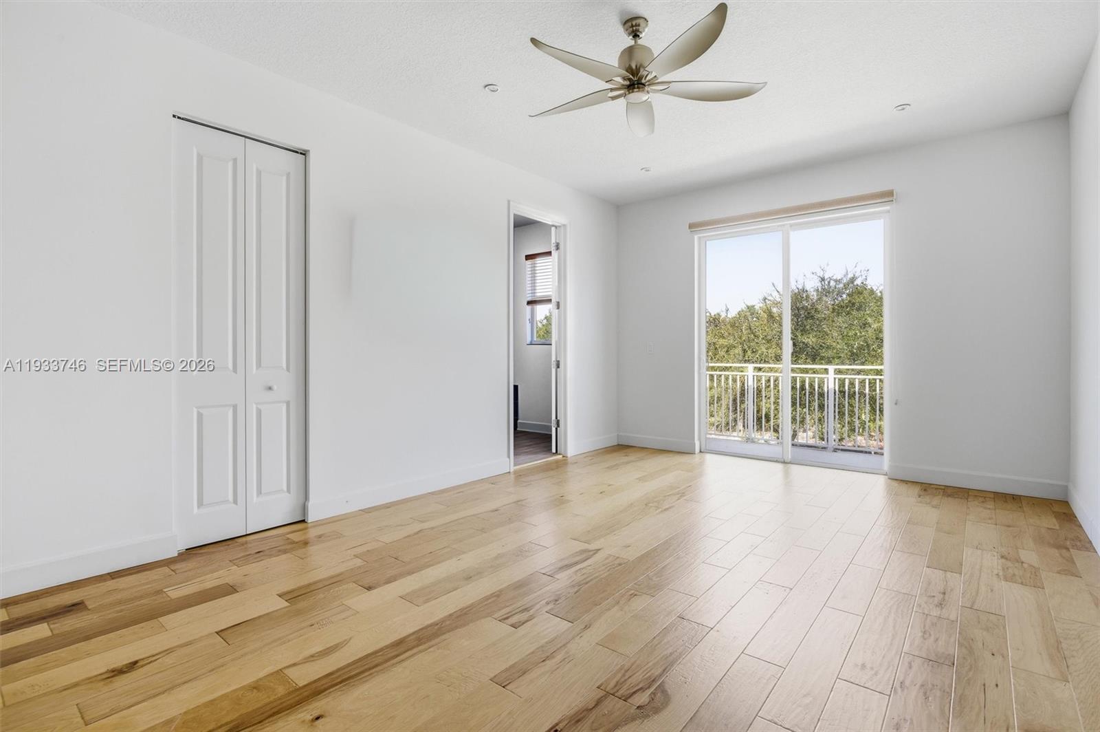 4857 Northwest 16th Terrace Boca Raton, FL 33431 - Photo 10 of 45 a view of an empty room with wooden floor and a window