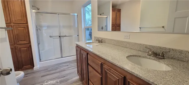 a bathroom with a granite countertop sink mirror and shower