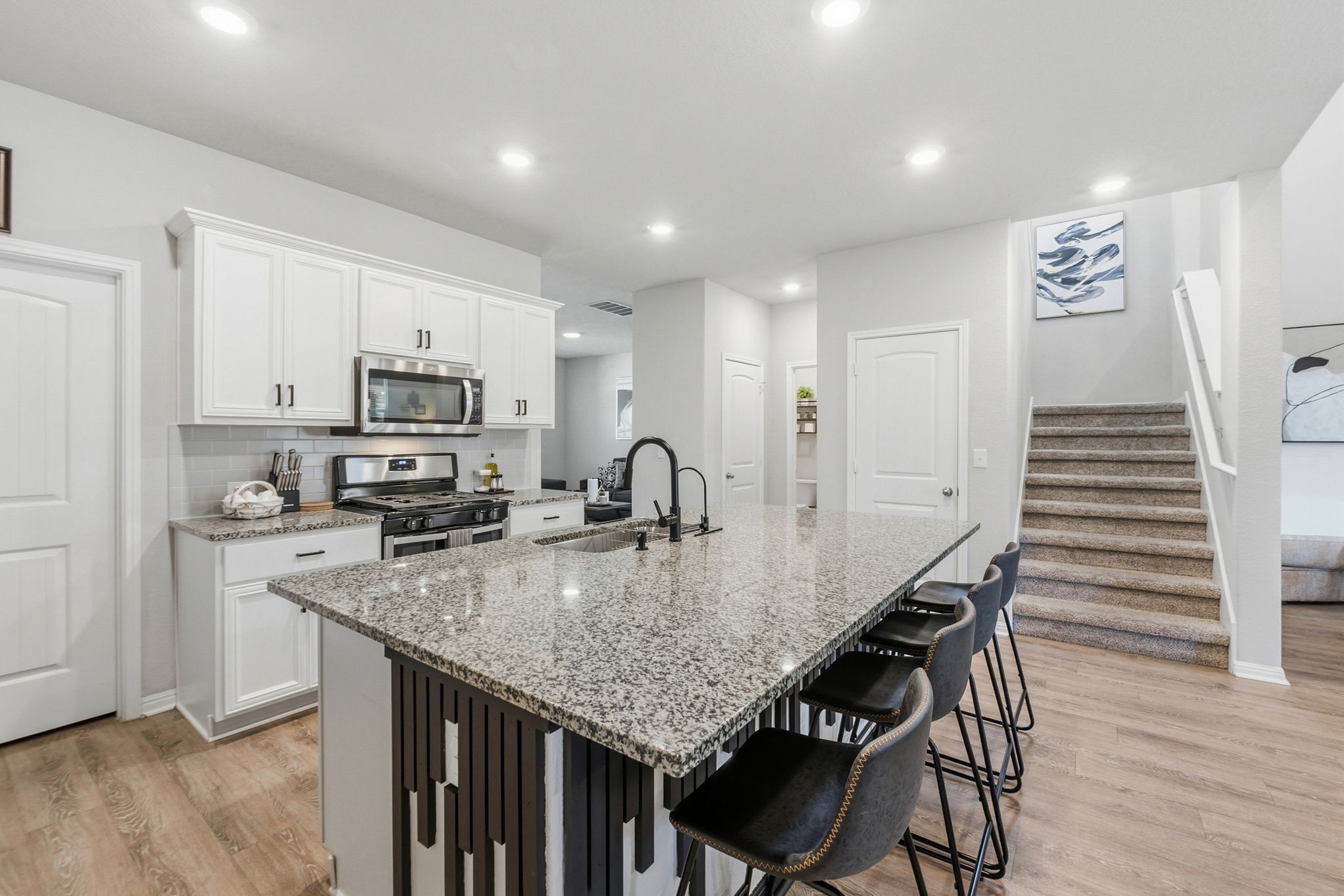 142 Brunnen Way Georgetown, TX 78626 - Photo 3 of 22 A well-appointed kitchen showcasing a spacious island with bar seating and seamless flow into adjacent living areas.
