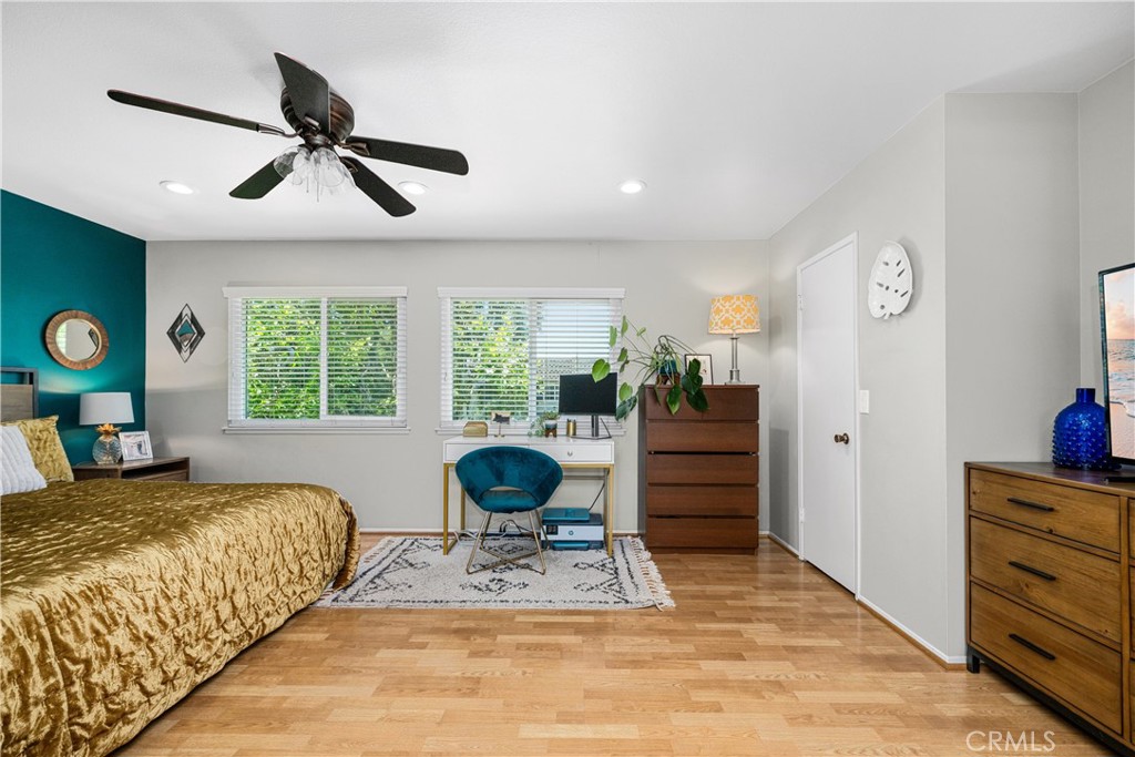 4237 Larwin Avenue Cypress, CA 90630 - Photo 25 of 48 a bedroom with a bed a chandelier and a window