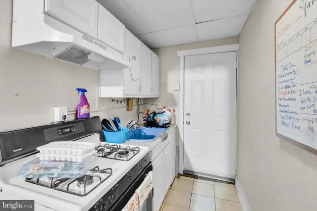 a living room with furniture and a gym machine