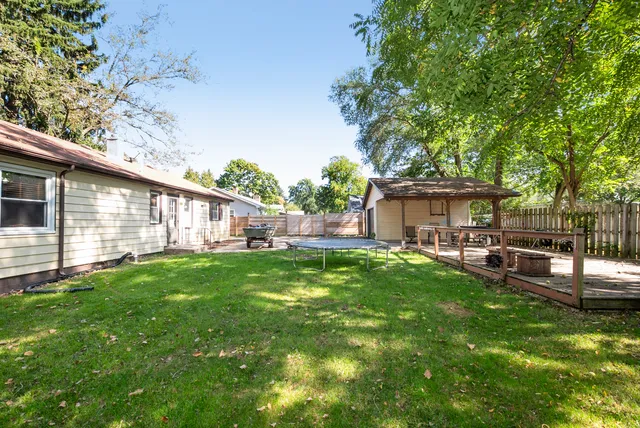 a view of a house with backyard and sitting area