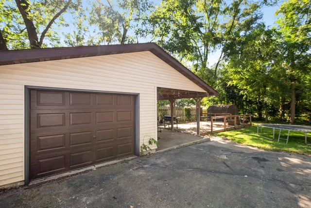 a view of a house with a patio and backyard