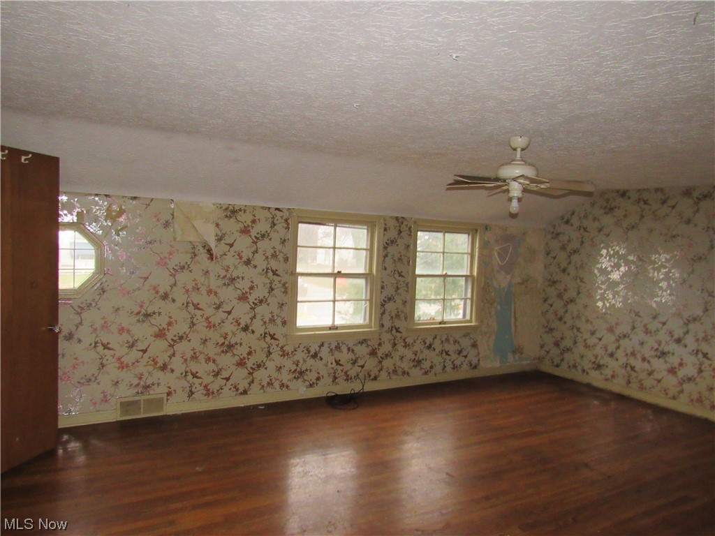 2350 North Taylor Road Cleveland, OH 44112 - Photo 18 of 24 Spare room with dark hardwood / wood-style flooring, ceiling fan, and a textured ceiling