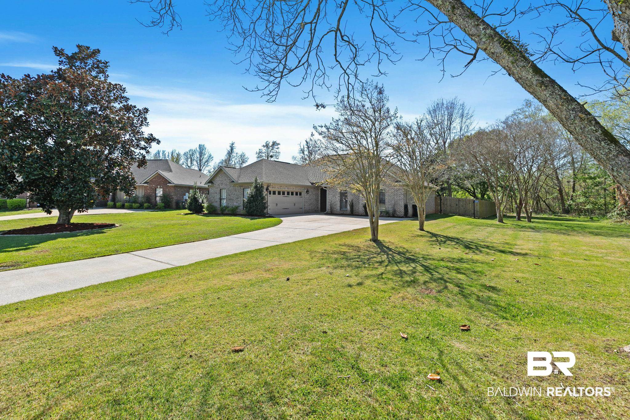 9584 Sanibel Loop Daphne, AL 36526 - Photo 2 of 48 View of front of property featuring driveway, stone siding, and a garage