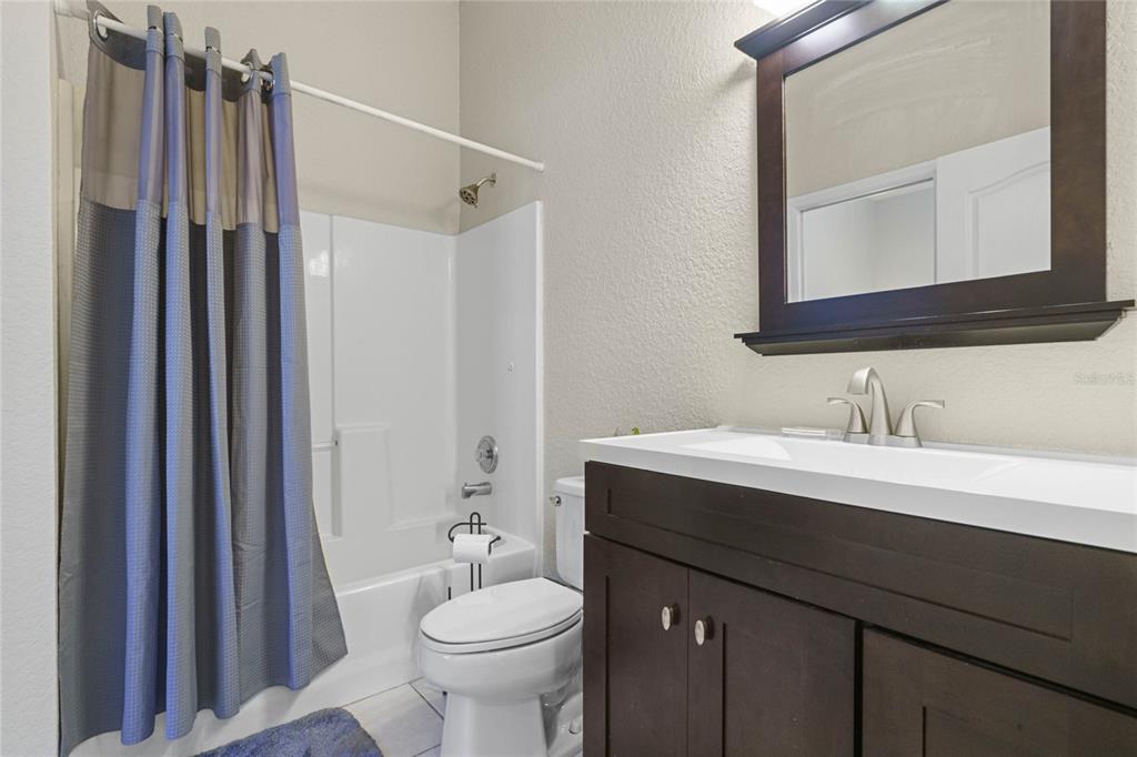 715 Magnolia Street Windermere, FL 34786 - Photo 18 of 44 a bathroom with a sink vanity mirror and toilet