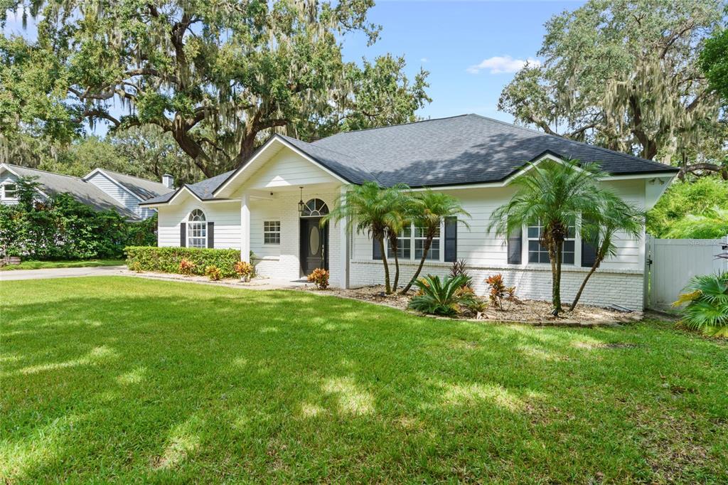 715 Magnolia Street Windermere, FL 34786 - Photo 2 of 44 a front view of a house with a yard and green space