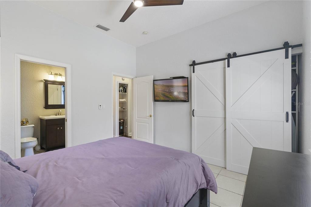 715 Magnolia Street Windermere, FL 34786 - Photo 22 of 44 a bedroom with a bed and a flat screen tv