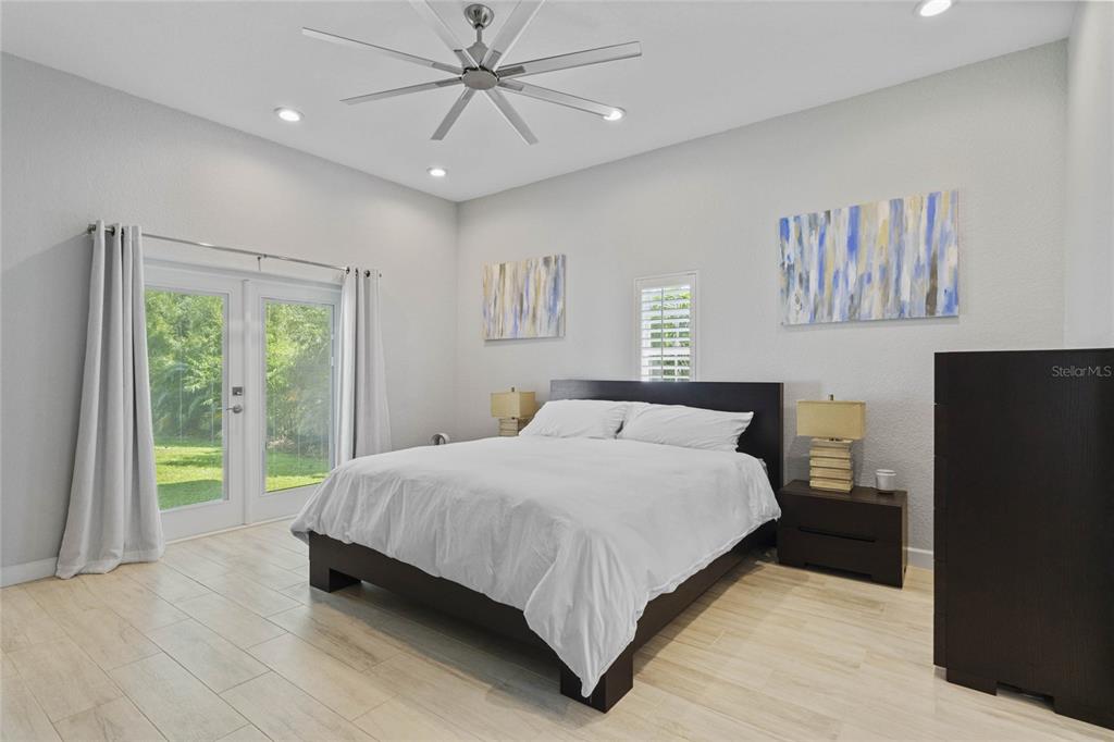 715 Magnolia Street Windermere, FL 34786 - Photo 24 of 44 a bedroom with a large bed and a chandelier