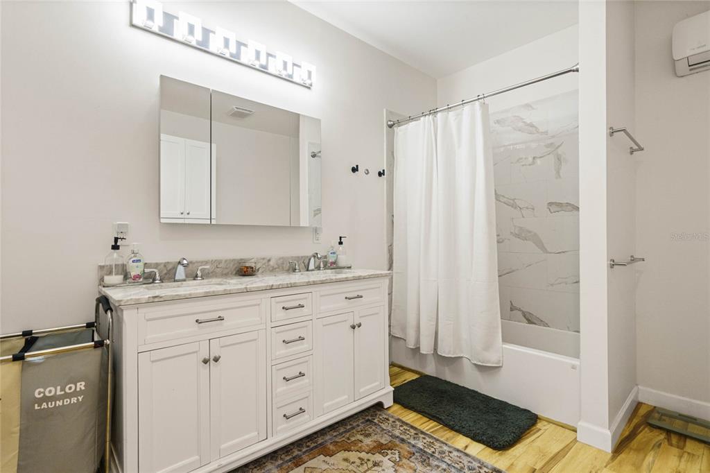 715 Magnolia Street Windermere, FL 34786 - Photo 31 of 44 a bathroom with a sink a mirror and a shower