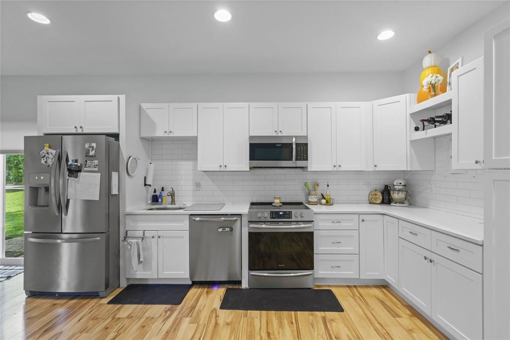 715 Magnolia Street Windermere, FL 34786 - Photo 34 of 44 a kitchen with stainless steel appliances a stove a sink and a refrigerator