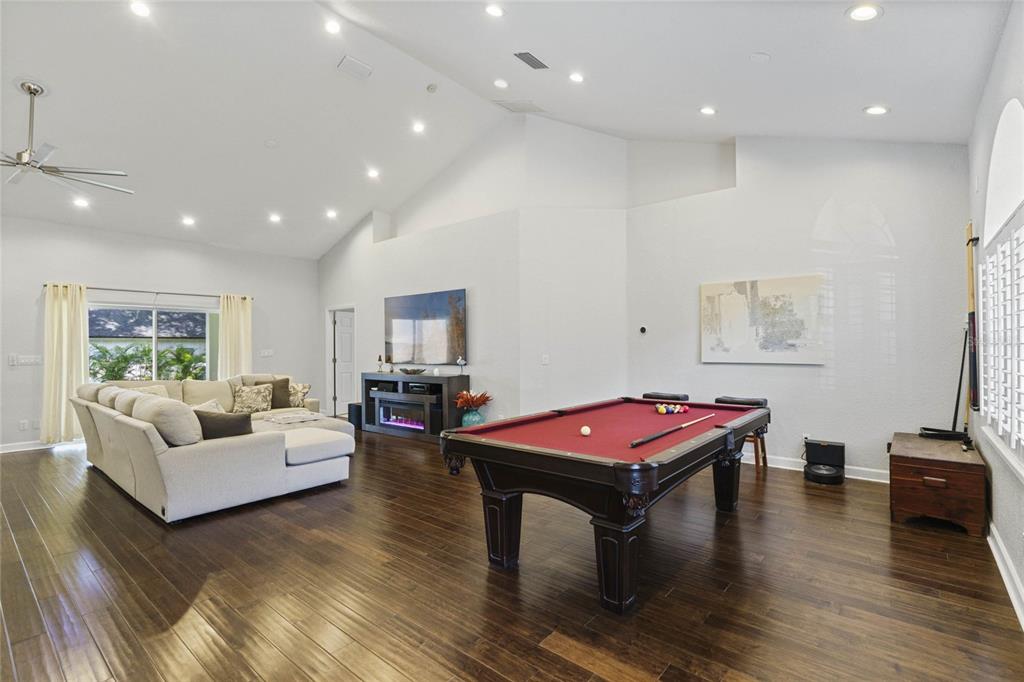 715 Magnolia Street Windermere, FL 34786 - Photo 6 of 44 a living room with furniture a flat screen tv and a pool table