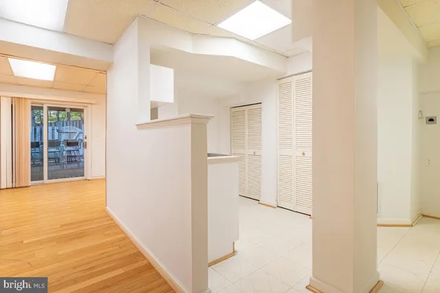 a view of a hallway with wooden floor and entryway
